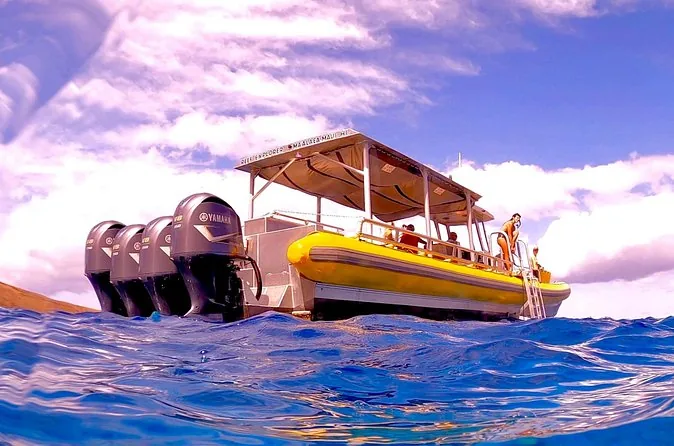 A small yellow boat with a canopy on blue water
